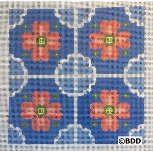 A blue and white tile with pink flowers.