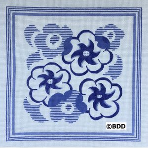 A blue and white flower design on a tile.