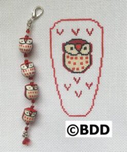 A red and white owl bracelet with a bead on it.
