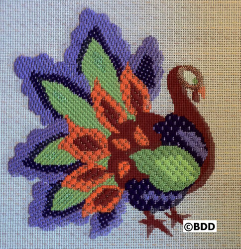 Colorful embroidered peacock on canvas background.