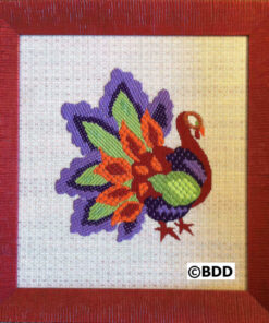 Colorful peacock embroidery in wooden frame.