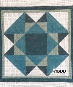 A blue and white quilt block on a canvas.