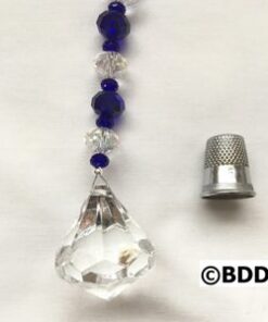A close up of a crystal bead with a thimble
