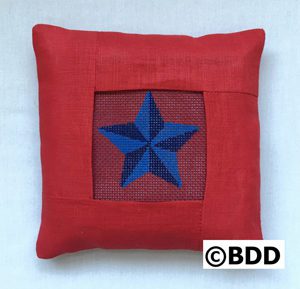 A red pillow with a blue star on it.