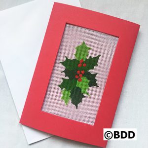 A red frame with a picture of a holly leaf.