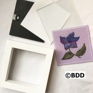 A white frame with some fabric on it