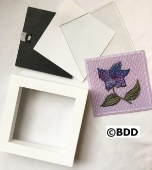 A white frame with some fabric on it