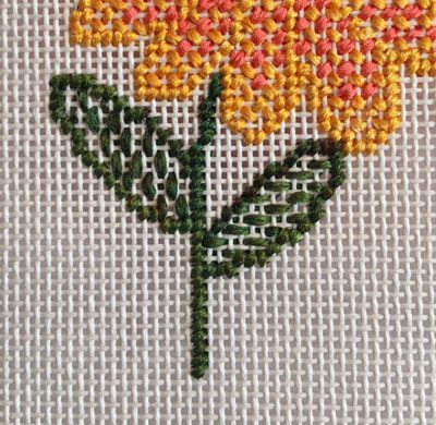 A close up of the flower on a cross stitch pattern