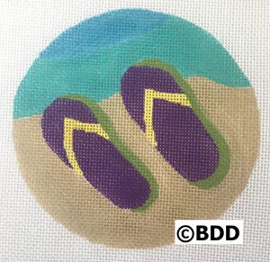 A round canvas with purple flip flops on it.