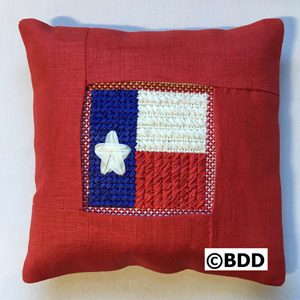 A red pillow with a star on it.