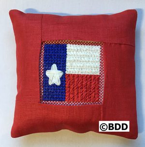 A red pillow with a star on it.