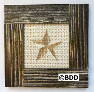 A cross stitch picture of a star in the middle of a frame.