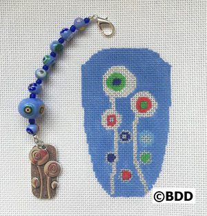 A blue bead and a piece of art