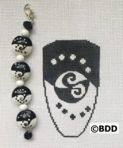 Black and white beaded charm with a design.