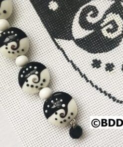 Black and white bead bracelet with a charm.