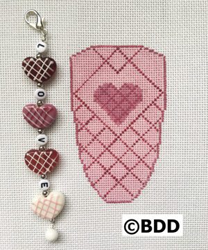 Embroidered pink heart with "love" charm.