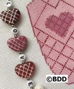 A close up of three hearts on a chain