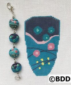 A blue bag with flowers and beads on it.