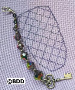 A key chain with a diamond pattern and beads.