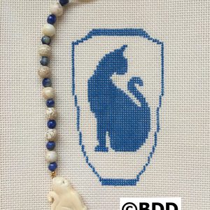 A cross stitch of a cat and bead.