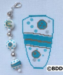 A blue and white cross stitch pattern with beads.