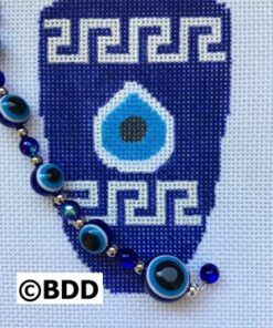 A blue and white cross stitch pattern with evil eye beads.