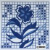 A blue and white tile with a flower on it.