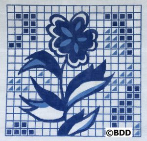 A blue and white tile with a flower on it.