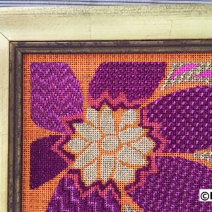 A cross stitch pattern of an orange and purple flower.