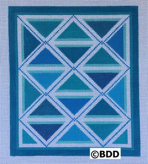 A blue and white quilt with a border.