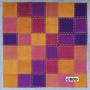 A square quilt with purple, orange and pink squares.