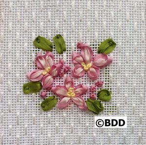 A close up of some pink flowers on a white cloth