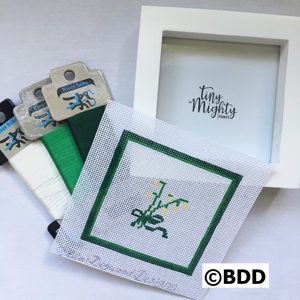 A picture frame with some green and white designs on it