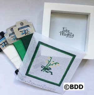 A picture frame with some green and white designs on it