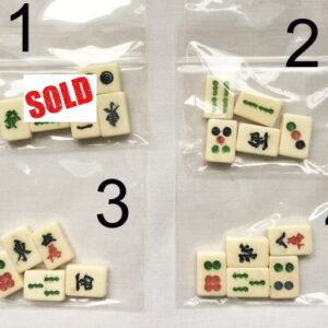 A set of four different mahjong tiles in bags.