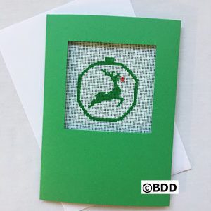 A green card with a picture of a reindeer in the middle.