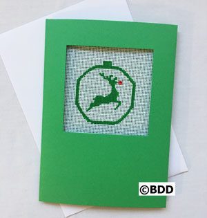 A green card with a picture of a reindeer in the middle.