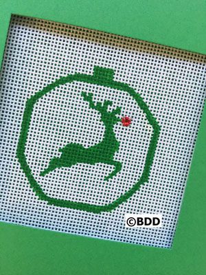 A green cross stitch picture of a reindeer.