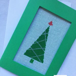 A green frame with a christmas tree on it.