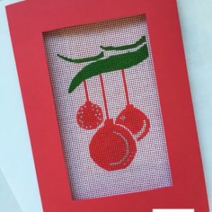 A red frame with a picture of christmas ornaments hanging from it.