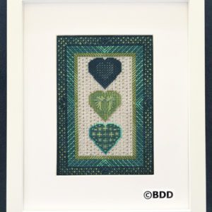 A framed picture of three hearts in green.