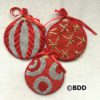 Three christmas ornaments made from red and white fabric.