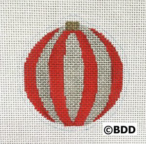 A red and white striped ornament sitting on top of a table.