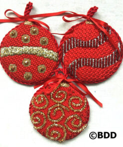 Three red ornaments with gold and silver designs.