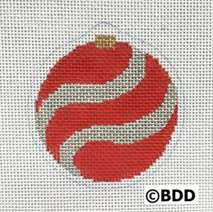 A red and white ornament sitting on top of a table.