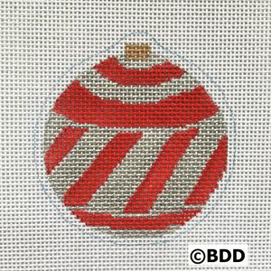 A red and white striped ornament sitting on top of a table.