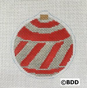 A red and white striped ornament sitting on top of a table.