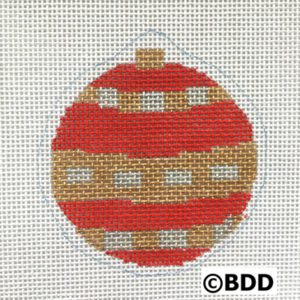 A red and gold ornament sitting on top of a table.