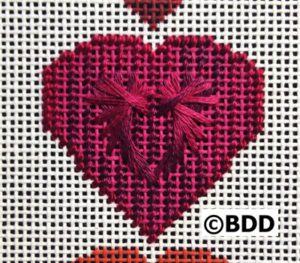 Pink stitched heart motif on canvas