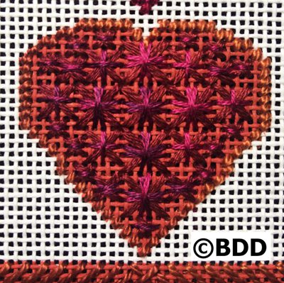 A heart made of red and purple flowers.